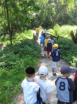Local schoolchildren visit Teaneck Creek and walk through the Conservancy site on the newly built trail system, July 2006.